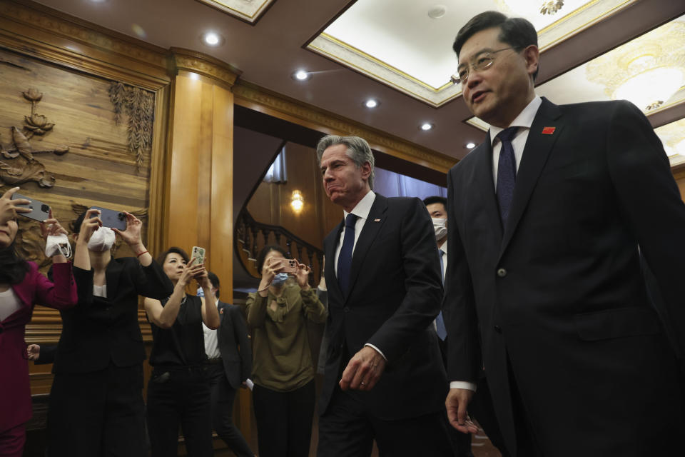 U.S. Secretary of State Antony Blinken, center, walks with Chinese Foreign Minister Qin Gang, right, at the Diaoyutai State Guesthouse in Beijing, China, Sunday, June 18, 2023. (Leah Millis/Pool Photo via AP)