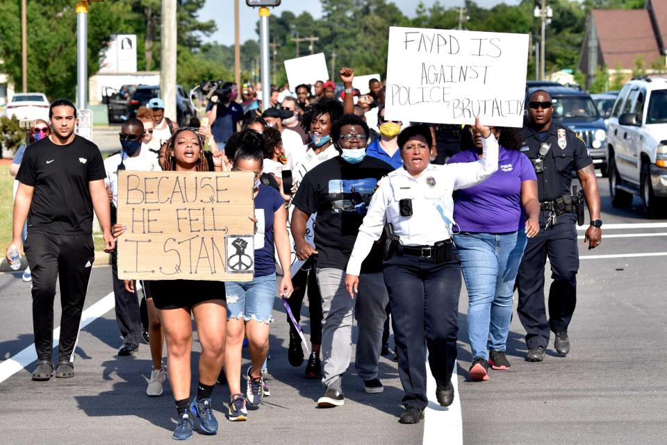 Protesters, including Fayetteville Police Chief Gina Hawkins, participated in a march along Cliffdale Road in June of 2020.