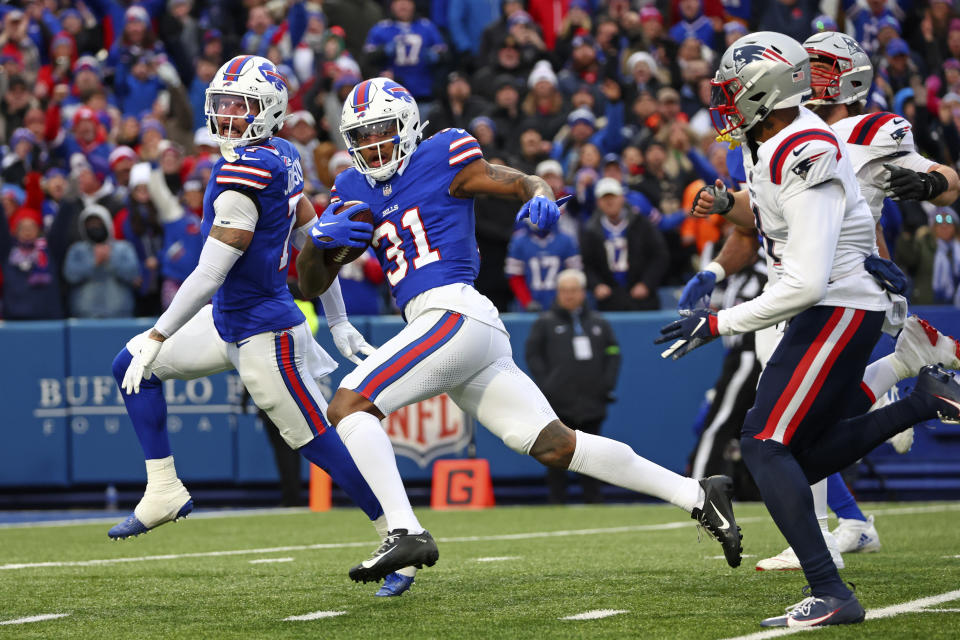 Buffalo Bills cornerback Rasul Douglas (31) returns an interception for a touchdown during the first half of an NFL football game against the New England Patriots in Orchard Park, N.Y., Sunday, Dec. 31, 2023. (AP Photo/Jeffrey T. Barnes )