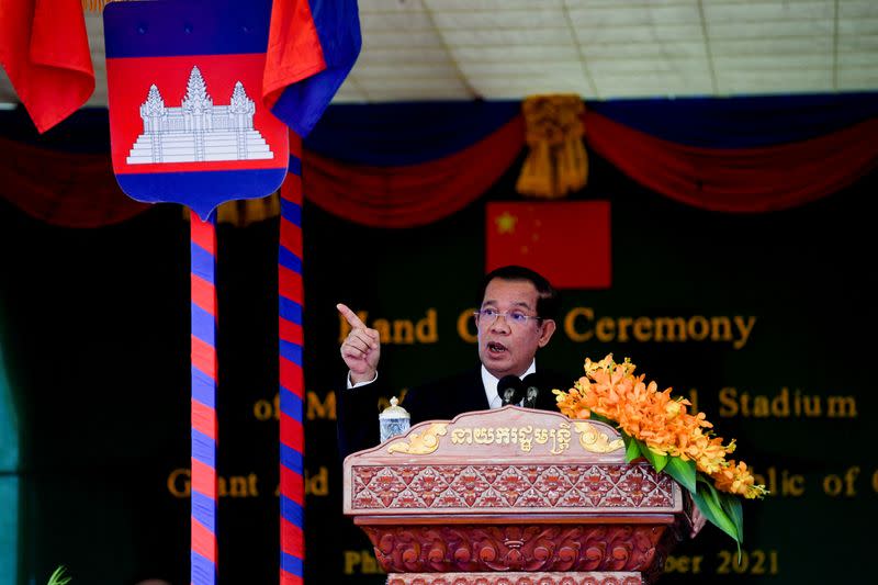 FILE PHOTO: Cambodian Prime Minister Hun Sen and China's State Councillor and Foreign Minister Wang Yi attend a handover ceremony at the Morodok Techo National Stadium, in Phnom Penh