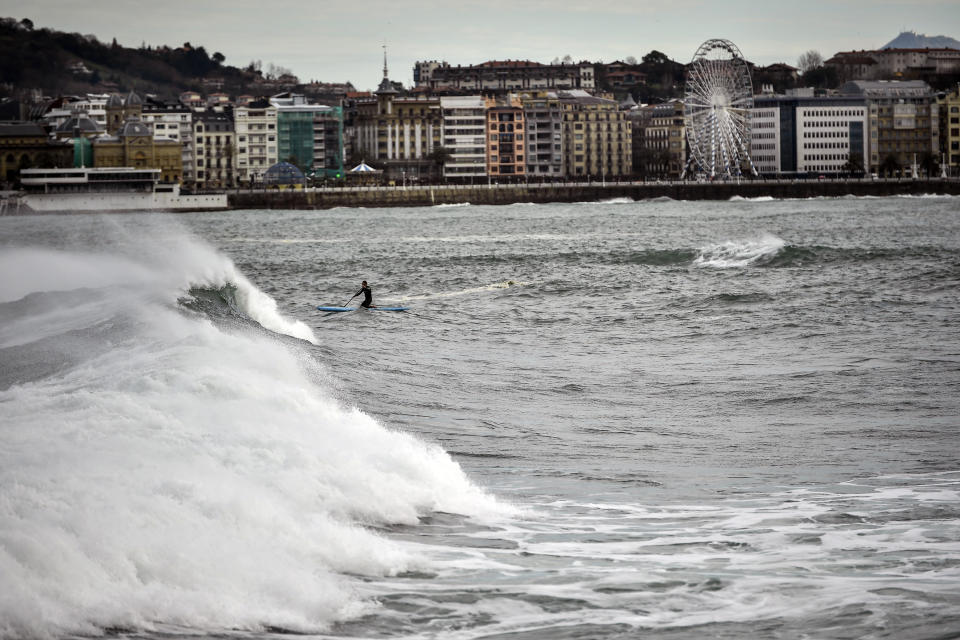 A giant wave crashes in front of the La Concha beach, during a high tide in San Sebastian, northern Spain, Sunday, Dec. 22, 2019. Spain experienced high winds and heavy rain as a storm reached the northern Iberian Peninsula from the Atlantic. (AP Photo/Alvaro Barrientos)