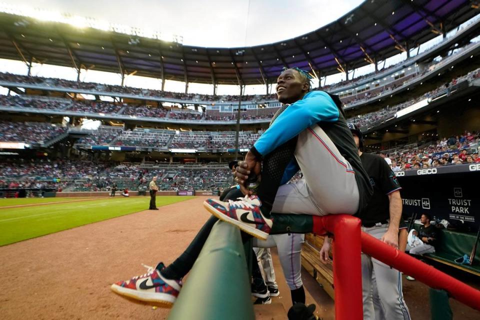 Miami Marlins second baseman Jazz Chisholm Jr. watches from the dugout railing between innings of the team’s baseball game against Atlanta Braves on Friday, May 27, 2022, in Atlanta. Chisholm was not in the starting lineup. (AP Photo/John Bazemore)