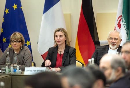 European Union Political Director Helga Schmid (L), European Union High Representative Federica Mogherini (C) and Iranian Foreign Minister Javad Zarif wait with others for a meeting with officials from P5+1, the European Union and Iran at the Beau Rivage Palace Hotel in Lausanne March 31, 2015. REUTERS/Brendan Smialowski/Pool