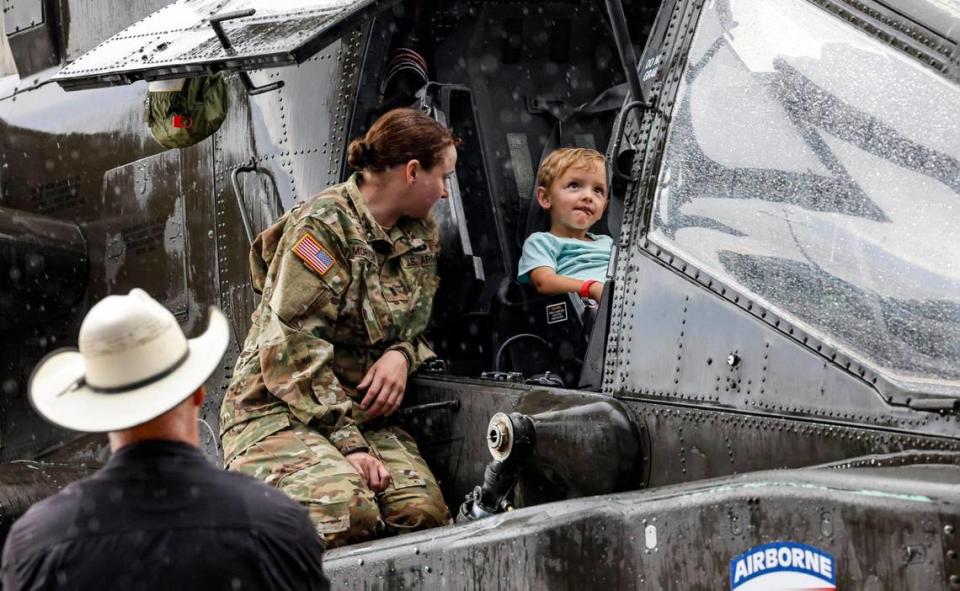 Myles Sutherland, 3, gets a front seat tour of an Apache Helicopter with US Army chopper pilot Megan Morton during the National Salute to America’s Heroes presented by Hyundai Air & Sea Show/U.S. Army Salute Fest at the US Coast Guard Air Station in Opa-locka, Florida on Friday, May 26, 2023.