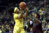 Oregon's Minyon Moore, left, goes up to shoot against Texas Southern's Ciani Cryor during the first quarter of an NCAA college basketball game in Eugene, Ore., Saturday, Nov. 16, 2019. (AP Photo/Chris Pietsch)