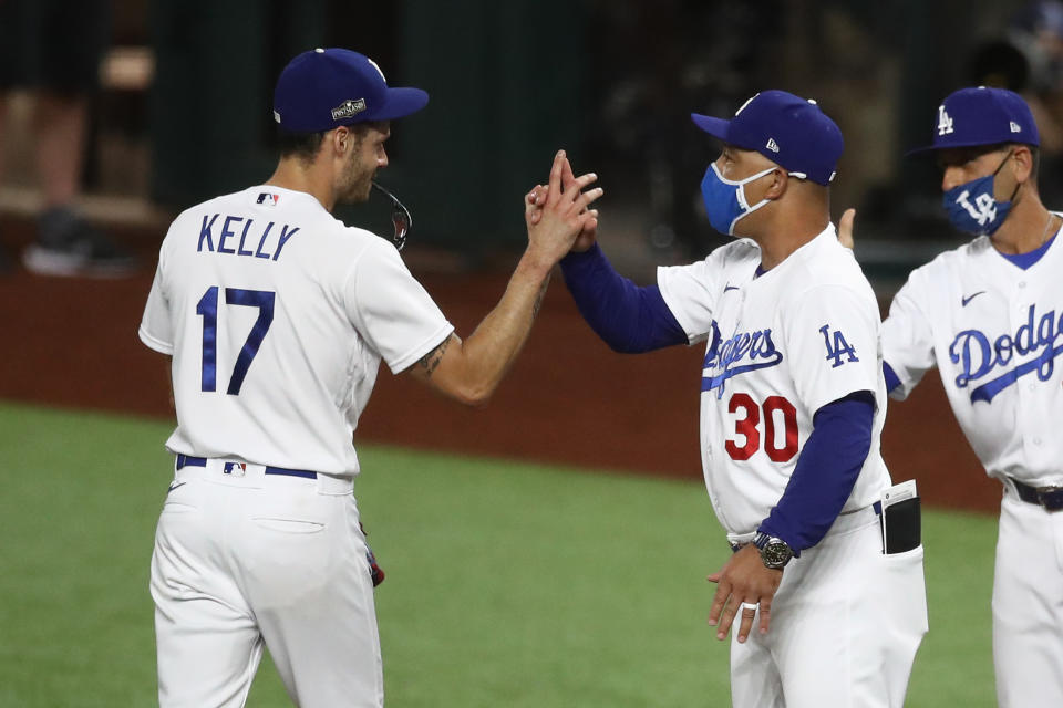 ARLINGTON, TEXAS - OCTOBER 07: Joe Kelly #17 of the Los Angeles Dodgers celebrates with manager Dave Roberts after defeating the San Diego Padres 6-5 in Game Two of the National League Division Series at Globe Life Field on October 07, 2020 in Arlington, Texas. (Photo by Ronald Martinez/Getty Images)