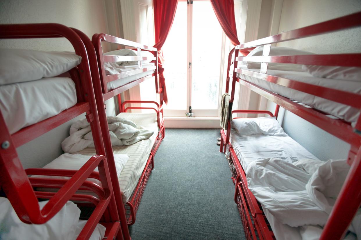 View of red stacking beds in light room of Bed Breakfast hotel.