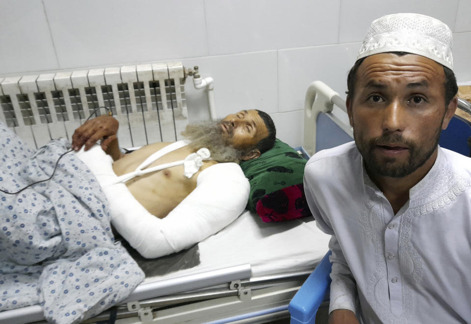 A wounded man receives treatment in a hospital, after a bombing at a mosque in the town of Imam Saheb, in Kunduz Province in north of Kabul, Afghanistan, Friday, April 22, 2022. A Taliban official says a bombing at a mosque and religious school in northern Afghanistan on Friday killed at least 33 people, including students of a religious school. (AP Photo/Abdullah Sahil)