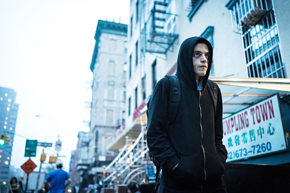 Rami Malek wearing a hoodie in a city