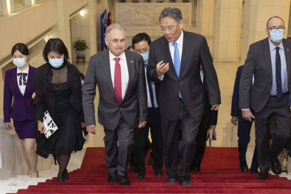 FILE- In this photo provided by the Department of Foreign Affairs and Trade (DFAT), Australian Trade and Tourism Minister Don Farrell, left, arrives for a meeting with Chinese Minister of Commerce Wang Wentao, right, in Beijing, Friday, May 12, 2023. China has lifted import bans on three Australian abattoirs in another sign of improving trade relations between the two countries. (Michael Godfrey/DFAT via AP, File)