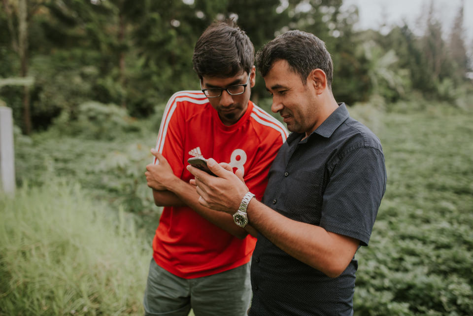 Singaporean journalist Prabhu Silvam in conversation with Ehsan Alli Ehsan, a Hazara refugee and one of Silvam's hosts in Cisarua, Indonesia in 2016. Ali used to work in a famous bakery in Kabul and had to flee because of the Taliban insurgency. PHOTO: Kenneth Lee