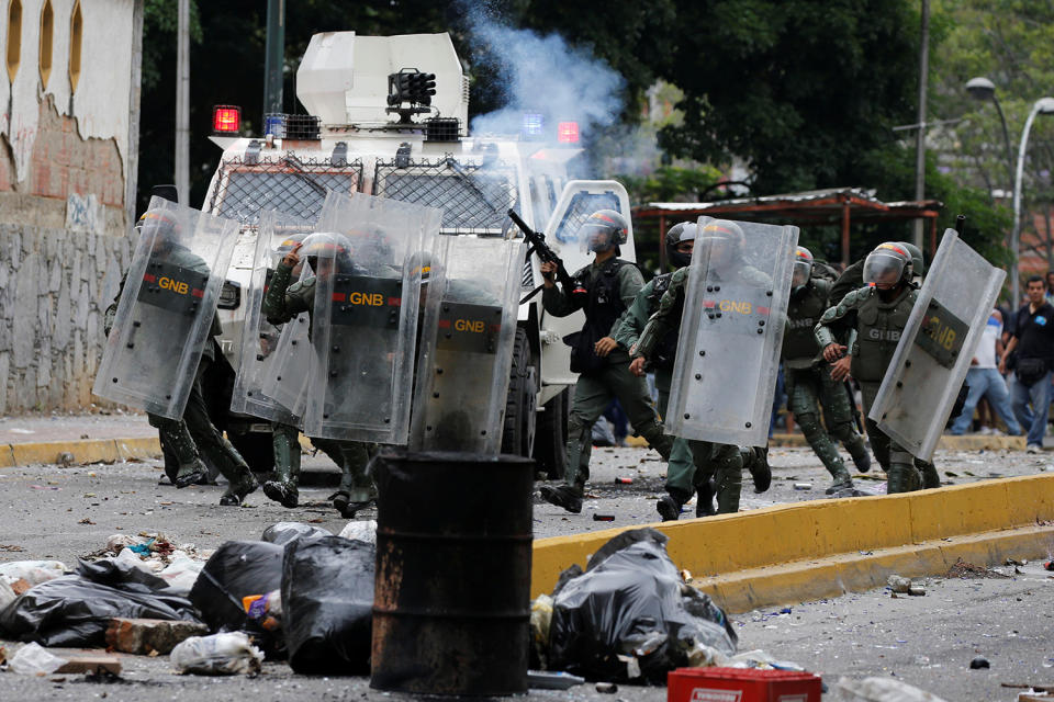 <p>Venezuelan National guards fire tear gas toward opposition supporters during a protest against Venezuela’s President Nicolas Maduro’s government in Caracas, Venezuela May 2, 2017. (Photo: Carlos Garcia Rawlins/Reuters) </p>