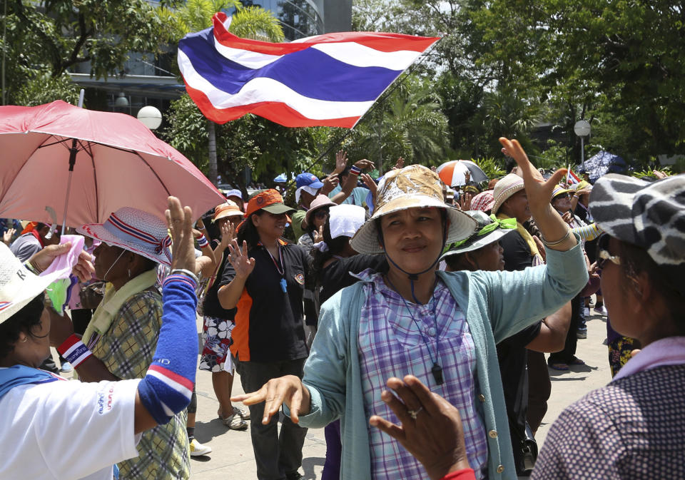 Anti-government protesters dance to the music during a rally at the compound of National Broadcasting Services of Thailand (NBT) Saturday, May 10, 2014 in Bangkok, Thailand. Protesters in Thailand ramped up their efforts to oust the government, laying siege to television stations, surrounding state offices, and demanding that lawmakers help them install a non-elected prime minister by Monday. (AP Photo/Apichart Weerawong)