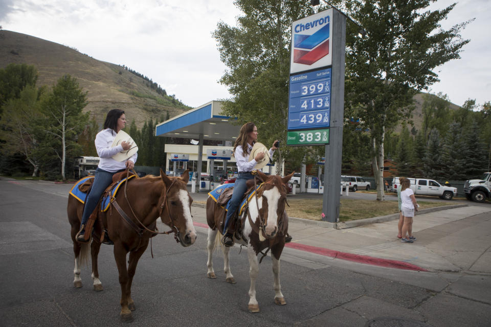 Citizen's Mounted Patrol Unit members Julie Sandretto and Gloria Courser pay their respects to Marine Lance Cpl. Rylee McCollum during a procession in Jackson, Wyo., Friday, Sept. 10, 2021. McCollum was one of the service members killed in Afghanistan after a suicide bomber attacked Hamid Karzai International Airport on Aug. 26. (AP Photo/Amber Baesler)