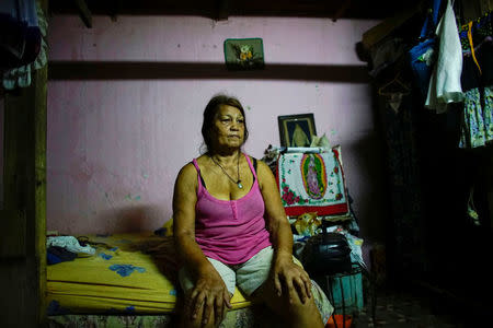 Berta Rodriguez, 71, whose neighbours were killed when the ceiling of their home collapsed during the passage of Hurricane Irma, according to state-run media, sits in her damaged home in Havana, Cuba, September 15, 2017. REUTERS/Alexandre Meneghini