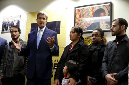 U.S. Secretary of State John Secretary Kerry (2nd L) meets with a group of refugees and staff members at a refugee resettlement center in Silver Spring, Maryland January 13, 2016. REUTERS/Yuri Gripas