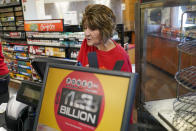 The display for the value of the jackpot flickers as it climbs as Della Reminar sells tickets for the Monday Powerball drawing with an annuity value of at least $1.9 billion, Monday, Nov. 7, 2022, at a convenience store in Renfrew, Pa. (AP Photo/Keith Srakocic)