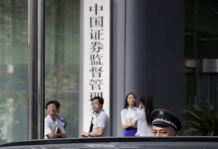 FILE PHOTO: A security guard stands outside the headquarters building of China Securities Regulatory Commission in Beijing, September 7, 2015. REUTERS/Jason Lee/File Photo