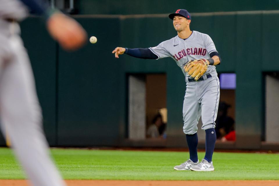 Cleveland Guardians second baseman Tyler Freeman, right, smiles and throws the ball after catching a line drive during the second inning of a baseball game against the Texas Rangers in Arlington, Texas on Sunday, Sept. 25, 2022. (AP Photo/Gareth Patterson)