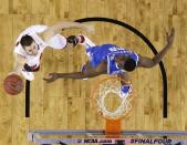 Wisconsin guard Josh Gasser, left, drives to the basket past Kentucky forward Alex Poythress during the first half of an NCAA Final Four tournament college basketball semifinal game Saturday, April 5, 2014, in Arlington, Texas. (AP Photo/David J. Phillip)