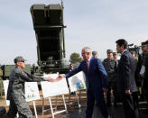 Australian Prime Minister Malcolm Turnbull (C) shakes hands with a Japanese Ground Self-Defense Force officer as he insects PAC-3 missile interceptors with Japanese Prime Minister Shinzo Abe (R) at Narashino exercise field in Funabashi, east of Tokyo, Japan January 18, 2018. REUTERS/Kim Kyung-Hoon