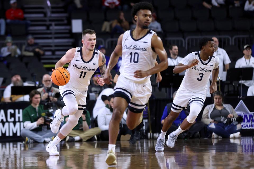 Oral Roberts' Carlos Jurgens (11) brings the ball up against North Dakota State during the first half of an NCAA college basketball game for the Summit League men's tournament championship Tuesday, March 7, 2023, in Sioux Falls, S.D. (AP Photo/Josh Jurgens)