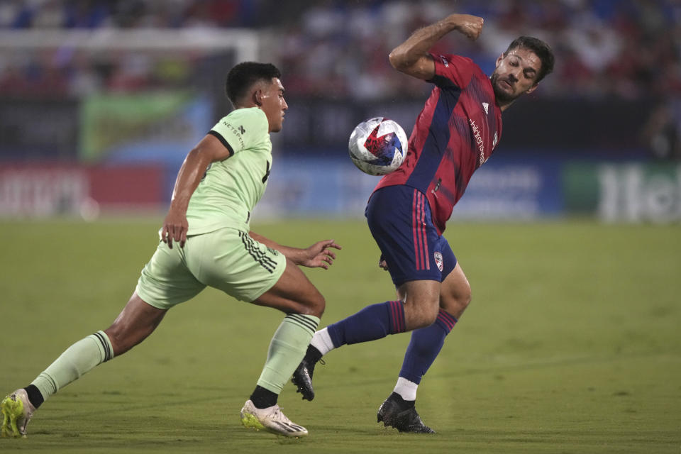 Austin FC midfielder Owen Wolff, left, moves the ball against FC Dallas forward Jesús Jiménez during the first half of an MLS soccer match Saturday, Aug. 26, 2023, in Frisco, Texas. (AP Photo/LM Otero)