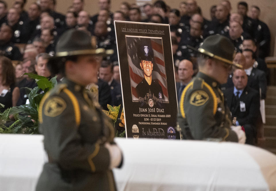 Honor guard and photo of Juan Diaz during funeral mass of slain Los Angeles Police Department officer Juan Diaz at the Cathedral of Our Lady of the Angels in Los Angeles, Calif., on Monday, Aug. 12, 2019. (Brian van der Brug /Los Angeles Times via AP, Pool)