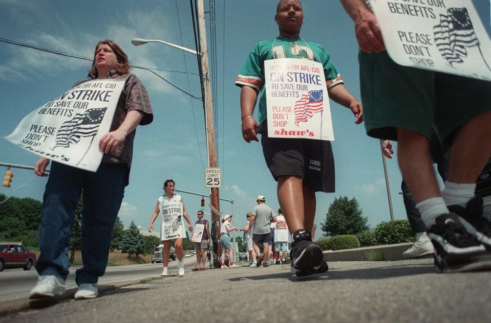 Striking workers walk the picket line in front of a Shaw's grocery store in Cranston in 1997.