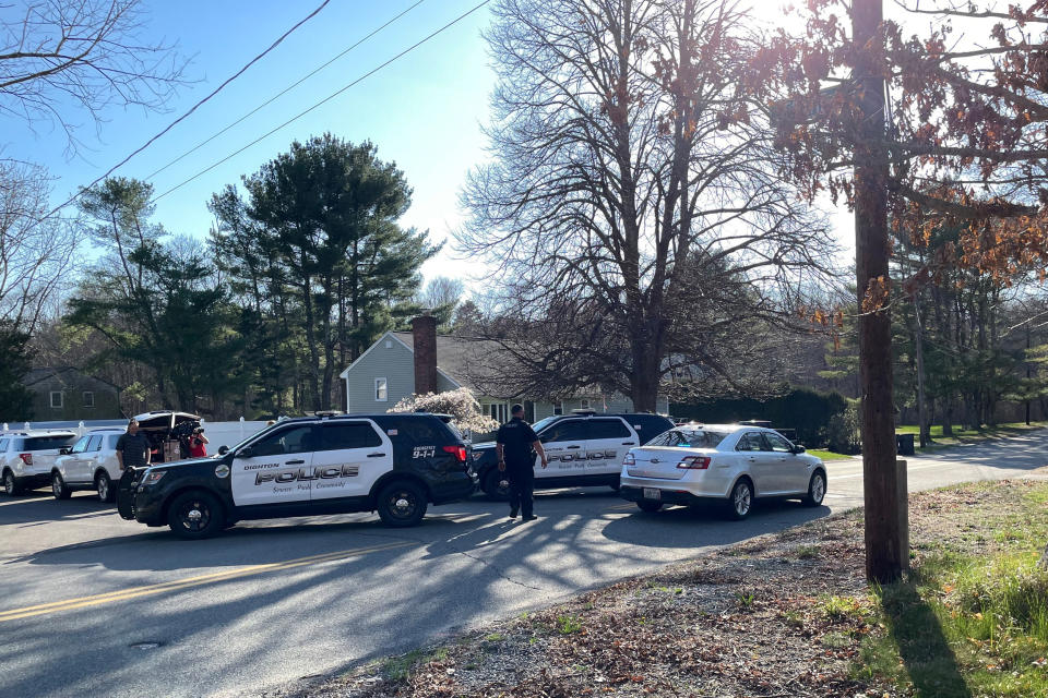 Local police maintain a roadblock as FBI agents conduct a search of a home in Dighton, Mass.