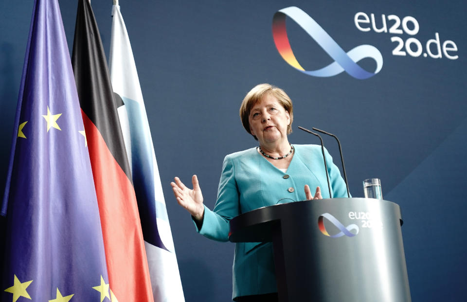 Germany's Chancellor Angela Merkel speaks to the press during a joint press conference with EU Commission President Ursula von der Leyen via videolink, in the foyer of the Federal Chancellery, in Berlin, Thursday, July 2, 2020. Merkel joined the President of the EU Commission, the three executive Vice-Presidents, the Commissioner for External Relations and the Commissioner for Internal Affairs to discuss the work programme as Germany took over the presidency of the Council of the EU. (Kay Nietfeld/dpa via AP)