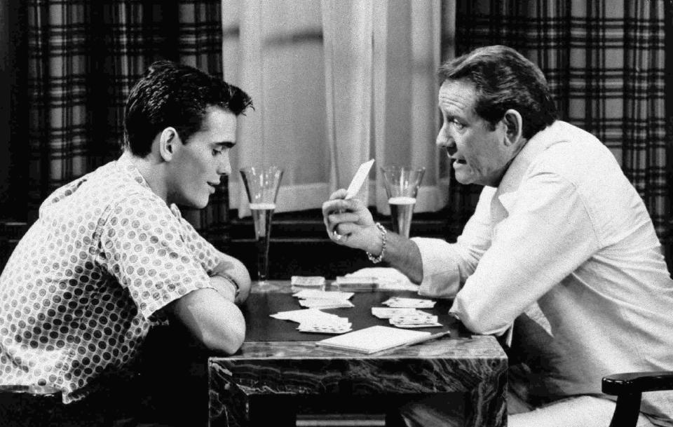 FILE - In this undated file photo, veteran actor Richard Crenna, right, and Matt Dillon play cards in scene from the 1984 film "The Flamingo Kid." (AP Photo/20th Century Fox, File)