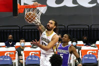 New Orleans Pelicans center Steven Adams, left, dunks as Sacramento Kings guard De'Aaron Fox (5) watches during the first quarter of an NBA basketball game in Sacramento, Calif., Sunday, Jan. 17, 2021. (AP Photo/Rich Pedroncelli)