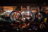 <p>Vendors and porters work in the background while homeless people sleep on the pavement in a working class district on August 19, 2016 in Manila, Philippines. (Dondi Tawatao/Getty Images) </p>