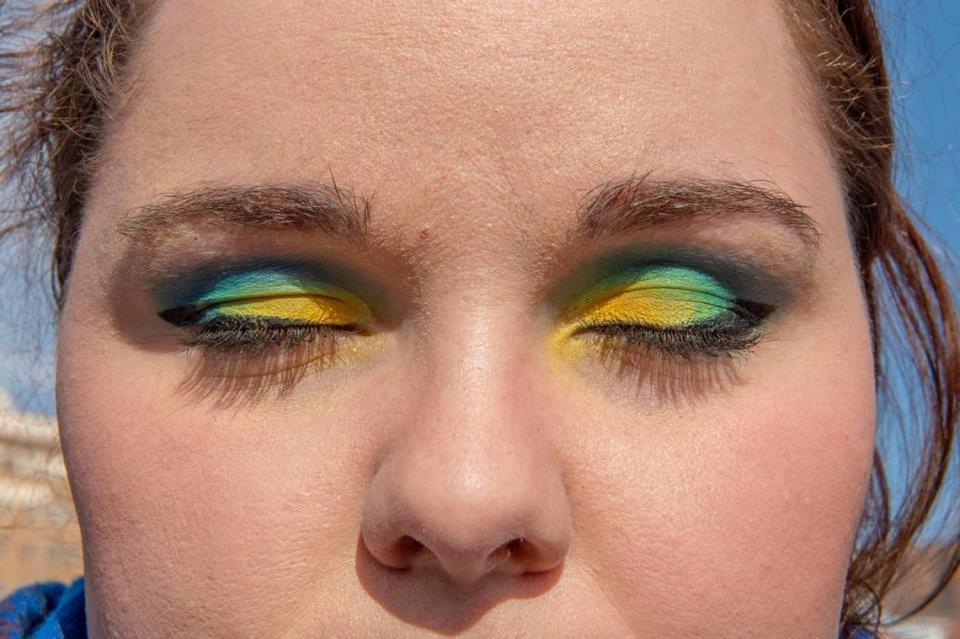 A demonstrator shows support for Ukraine by using the colors of the country’s flag as her eyeshadow at The Plaza on Saturday, Feb. 26, 2022. The protest was organized in response to the recent military invasion by Russia.