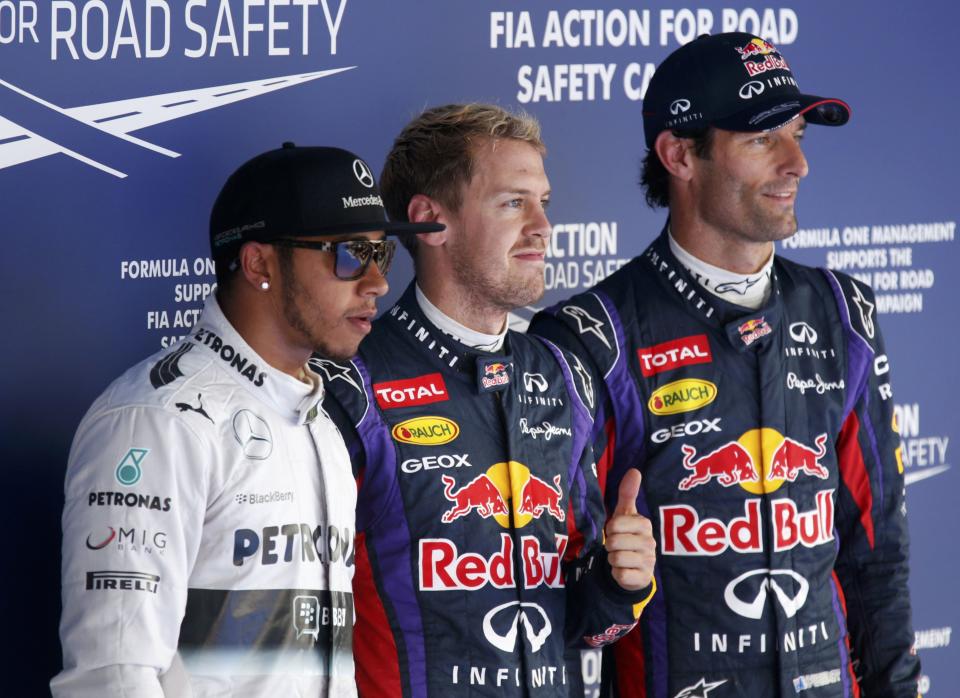 Red Bull Formula One driver Sebastian Vettel of Germany (C) gives a thumbs up after taking pole position as he poses with Mercedes Formula One driver Lewis Hamilton of Britain (L) and Red Bull Formula One driver Mark Webber of Australia after the qualifying session for the Korean F1 Grand Prix at the Korea International Circuit in Yeongam, October 5, 2013. Formula One championship leader Vettel will start Sunday's Korean Grand Prix on pole position for Red Bull with Hamilton's Mercedes alongside on the front row. REUTERS/Lee Jae-Won (SOUTH KOREA - Tags: SPORT MOTORSPORT F1)