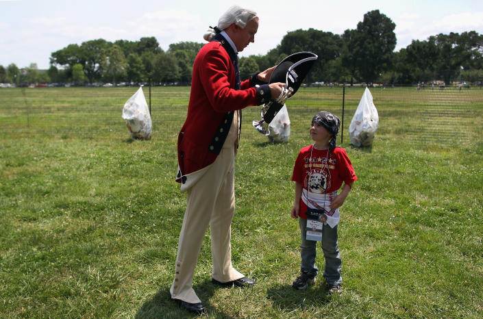 A young participant of the TAPS "Good Grief Camp" speaks with a member of the U.S. Army Old Guard on May 26, 2012 in Washington, DC. Five hundred military children and teens, most of whom lost a parent or sibling in the Afghan and Iraq wars, are attending the annual four-day "Good Grief Camp" in Arlington, Virginia and Washington, DC, which is run by TAPS (Tragedy Assistance Program for Survivors). The camp helps them learn coping skills and build relationships so they know they are not alone in the grief of their loved one. They meet others of their own age group, learn together and share their feelings, both through group activities and one-on-one mentors, who are all active duty or former military service members. Some 1,200 adults, most of whom are grieving parents and spouses, also attend the National Military Survival Seminar held concurrently with the children's camp. The TAPS slogan is "Remember the Love. Celebrate the Life. Share the Journey." (Photo by John Moore/Getty Images)