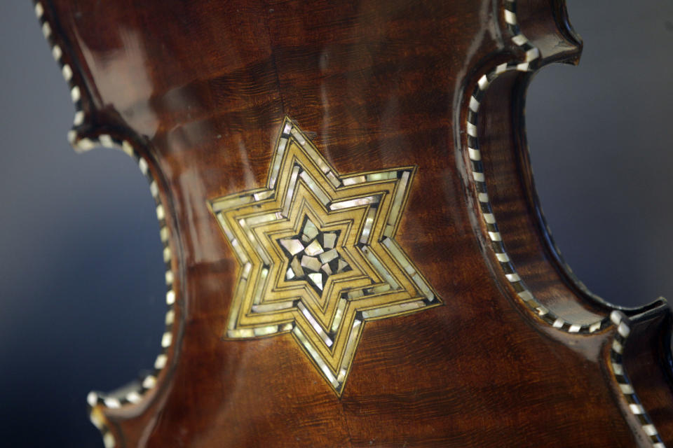 In this April 9, 2012 photo, the back of a violin showing a Star of David is shown on display at the Violins of Hope exhibit at the University of North Carolina in Charlotte, N.C. Eighteen violins recovered from the Holocaust and restored by Israeli violin maker Amnon Weinsten make their U.S. debut on Sunday, April 15. Some were played by Jewish prisoners in Nazi concentration camps, while others belonged to the Jewish Klezmer musical culture. (AP Photo/Chuck Burton)