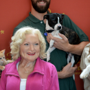<p> Betty White&apos;s wax Madame Tussaud&apos;s figure poses with along with many adoptable dogs, cats, puppies and kittens. </p>