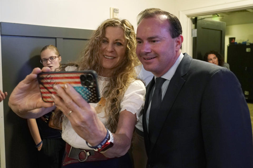 Sen. Mike Lee, R-Utah, poses for a selfie with a supporter during a Republican primary-night party Tuesday, June 28, 2022, in South Jordan, Utah. Lee defeated two challengers in the Republican Senate primary. (AP Photo/George Frey)
