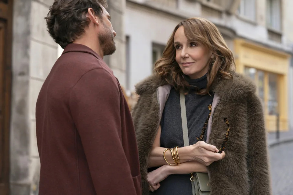 Arnaud Binard and Philippine Leroy-Beaulieu having a conversation outdoors in "Emily in Paris"