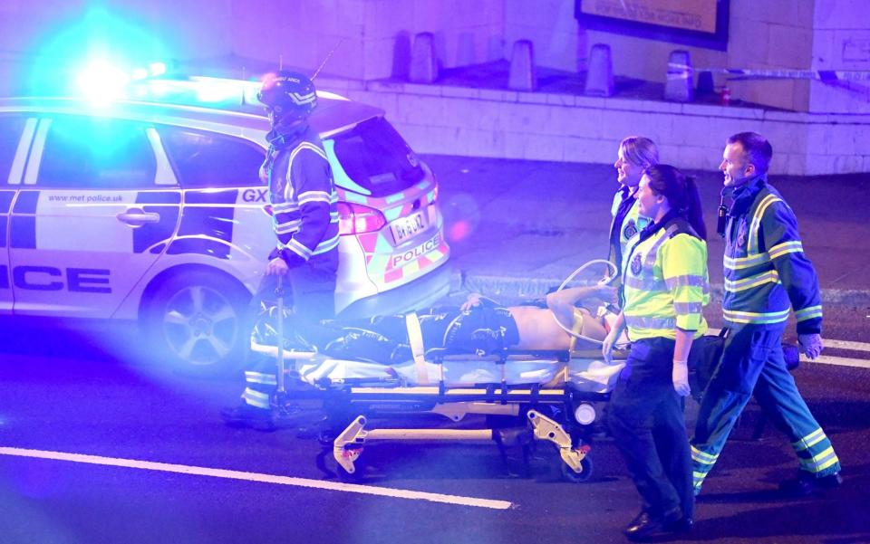 A victim is taken away on a stretcher by medics at Finsbury Park - Credit:  James Gourley/REX/Shutterstock