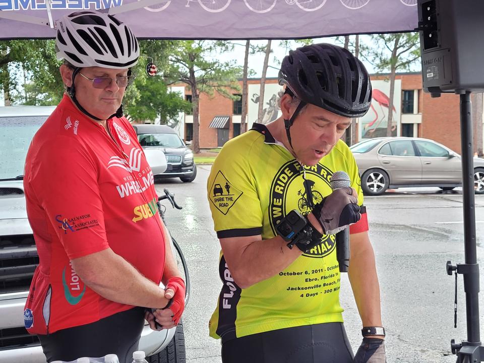 West Florida Wheelman president Jeff Williamson (left) and board member Chris Huffman (right) speak before the Ride of Silence, Huffman read the names of bicyclists who have been lost over the years.