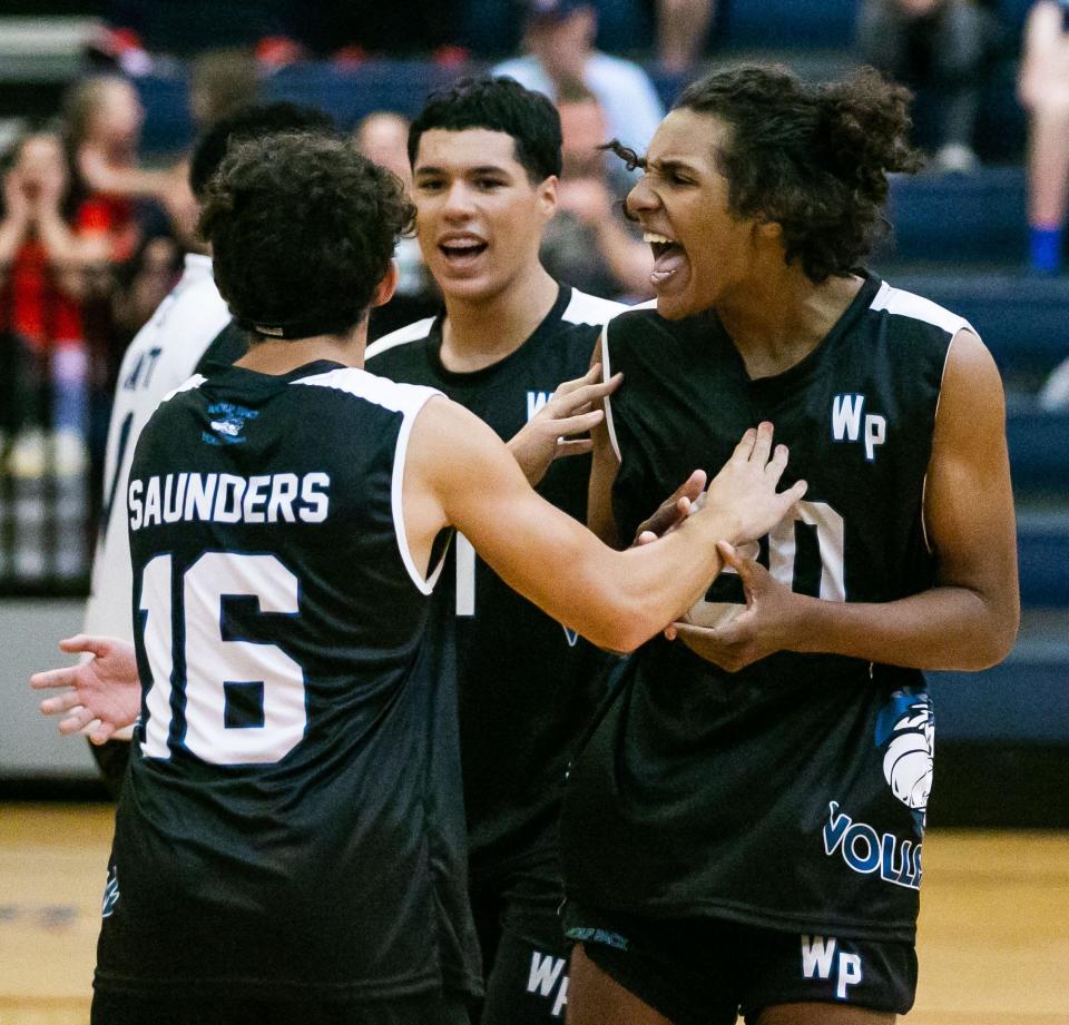 West Port (16) Matthew Saunders and West Port (20) Dylan Luke celebrate after winning the second set against the North Marion Colts. West Port won Wednesday night, April 27, 2022 at Vanguard High School in a district final match