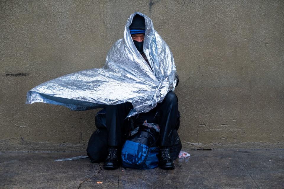 Maurice, 50, sits outside Fred Jordan Mission in Los Angeles on Friday.