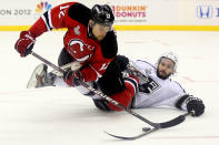 NEWARK, NJ - JUNE 09: Alexei Ponikarovsky #12 of the New Jersey Devils tries to handle the puck against Drew Doughty #8 of the Los Angeles Kings during Game Five of the 2012 NHL Stanley Cup Final at the Prudential Center on June 9, 2012 in Newark, New Jersey. (Photo by Elsa/Getty Images)
