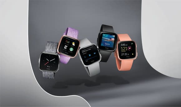 An assortment of Fitbit Versa smartwatches in different colors