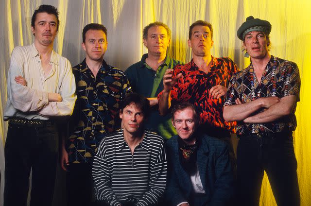 <p>Gie Knaeps/Getty</p> Studio portrait of The Pogues with Spider Stacy as singer, Philip Chevron, James Fearnley, Jem Finer, Andrew Ranken, Darryl Hunt, Terry Woods, Live Aid Festival, Puurs, Belgium in May 1992.