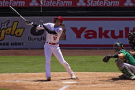 Los Angeles Angels' Shohei Ohtani, left, of Japan flies out as Oakland Athletics relief pitcher Liam Hendriks watches during the second inning of a baseball game Wednesday, Aug. 12, 2020, in Anaheim, Calif. (AP Photo/Mark J. Terrill)