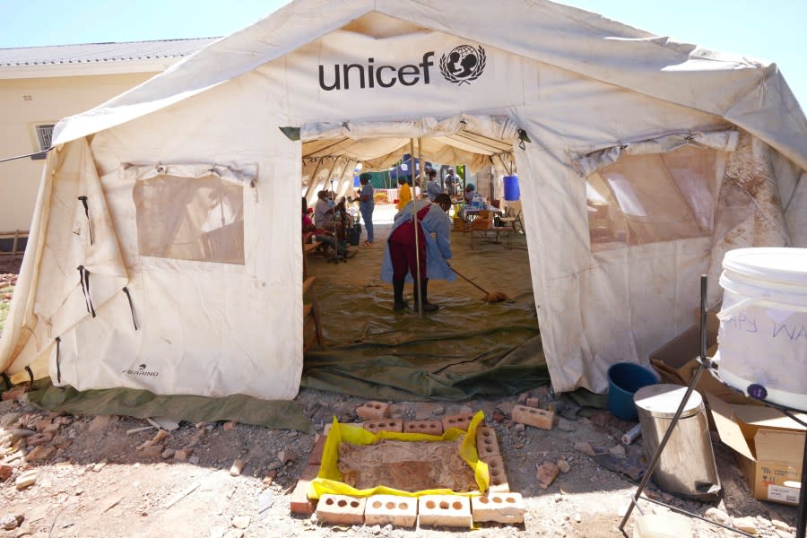 A health worker is seen cleaning inside a tent set aside for cholera patients at a clinic in Harare, Zimbabwe, Saturday Nov. 18, 2023. Zimbabwe is battling a cholera outbreak that has resulted in more than 150 suspected deaths countrywide. Health experts, authorities and residents blame the outbreak on acute water shortages and lack of access to sanitation and hygiene services (AP Photo/Tsvangirayi Mukwazhi)